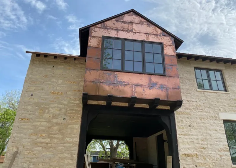 Copper metal panel facade on a stone building for Skylight Installation in South Bradenton