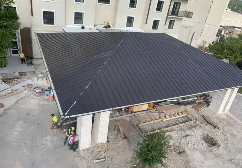 Metal roofing installation team working on a commercial building in South Bradenton